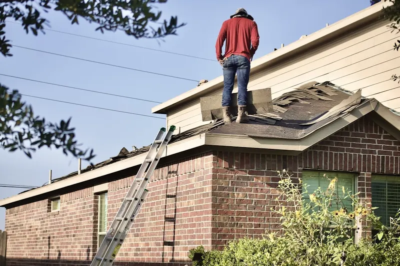 Professional roofer working on a residential roof in Newark Beach